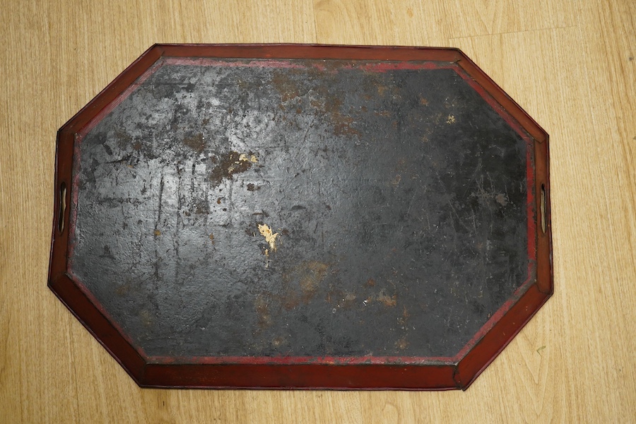 An early 19th century octagonal red painted toleware tray, possibly Pontypool, 66cm wide. Condition - poor